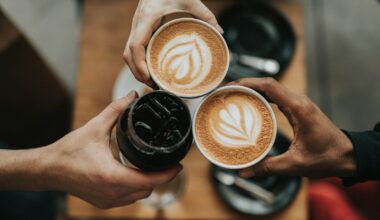 three person holding beverage cups