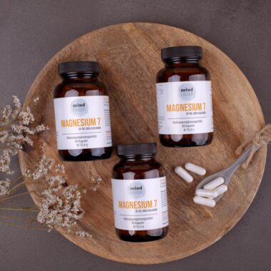 three bottles of magnesum on a wooden plate