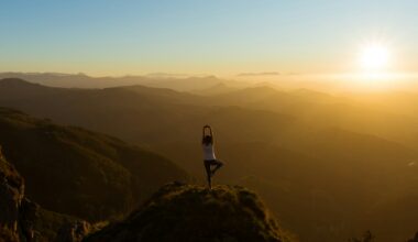 woman stretching on mountain top during sunrise
